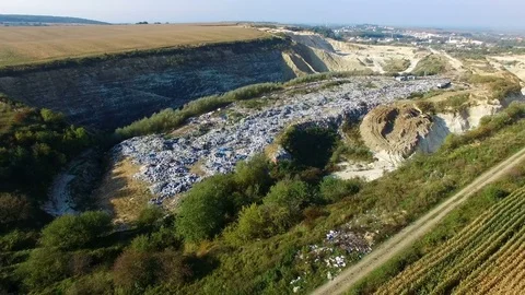 Fly around rubbish dump near weat agricultural fields. Aerial view Stock Footage 80981102