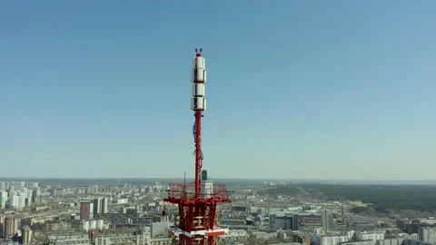 Fly around the telecommunications tower with cellular antennas on top with a Stock Footage 165349154