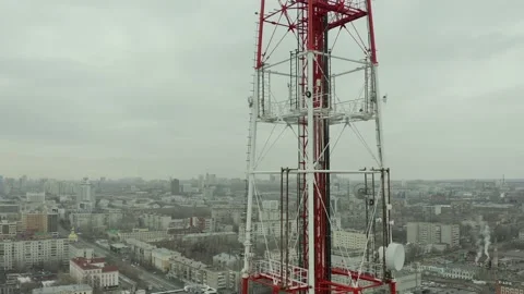 Fly around the telecommunications tower with view of metropolis, bright sun day Video stock 165347788