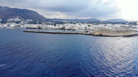 Fly away over dark blue sea from seaside town, Crete, Greece Stock Footage 95889340