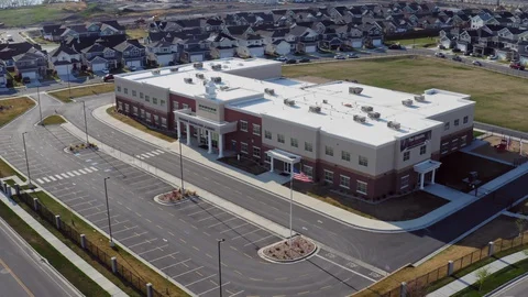 Fly away from vacant elementary school on beautiful spring day in April 2020 스톡 동영상 128783225