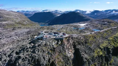 Fly away from a Viewpoint on the edge of a cliff surrounded by mountains Stock Footage 167263185