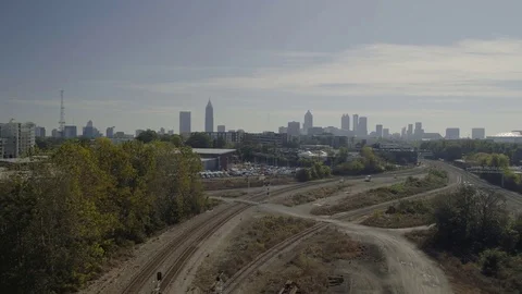 Fly back from Atlanta Skyline to traintracks Stock Footage 82448382
