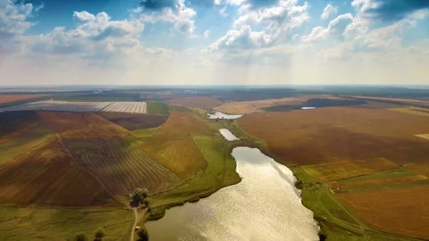 Fly back over lake and field Stock Footage 99327979