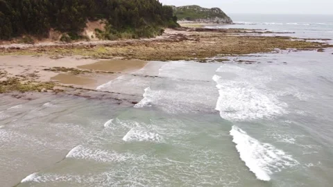 Fly backwards &amp; rotating 180 front in playa de Oyambre, Cantabria, Spain 4K P2 Stock Footage 155599099