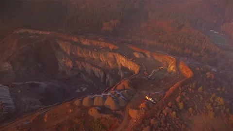 Fly Cam climb over a open cast mining complex in the evening Stock Footage 143537672