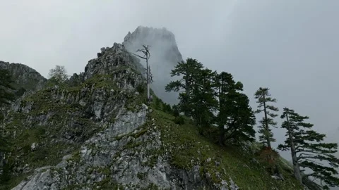 Fly close and low over mountain ridge with sharp rocks Video stock 249999821