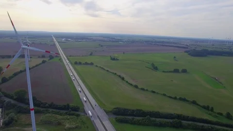 Fly close to wind turbine propellers spinning above road aerial 4k. Wind farm Stock Footage 79982841