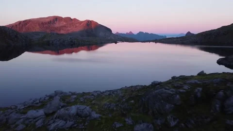 Fly down and across mountain lake at sunset Stock Footage 219785462