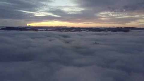 Fly down into the clouds during sunrise. Stock Footage 80003199