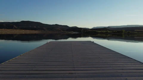 Fly down lake deck pier low angle Stock Footage 281511501