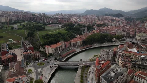 Fly down Nervión River downtown Bilbao - wide shot Stock Footage 223002301