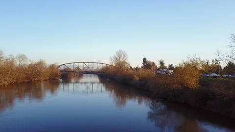 Fly down river and over bridge to reveal Mt Rainier Stock Footage 91466602