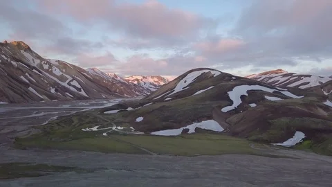 Fly down at sunset evening in rainbow volcanic mountains in Iceland Stock Footage 87703145