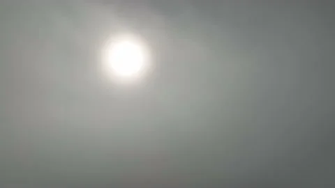 Fly down through thick cloud from clear sky with Sun above clouds to forest. Stock Footage 205527345