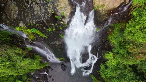 Fly down a waterfall in Indonesia Stock Footage 340970543