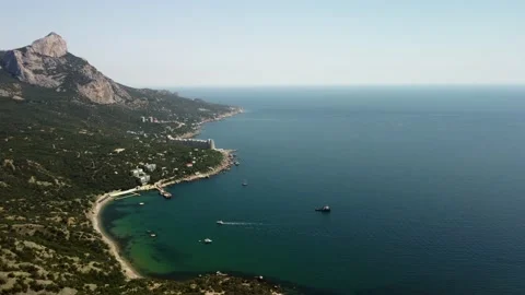 Fly a drone along a mountain with green trees Stock Footage 160466913