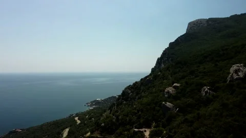 Fly a drone along a mountain with trees Stock Footage 160466927