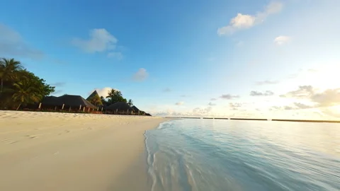 Fly a drone over a beach in the Maldives. Ocean and palm trees. Stock Footage 238373690