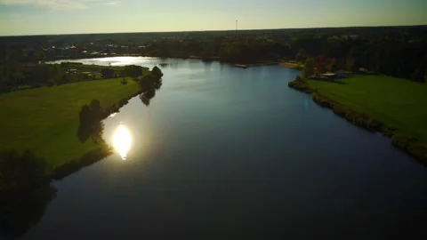 Fly a drone over the lake during sunset Stock Footage 162886637
