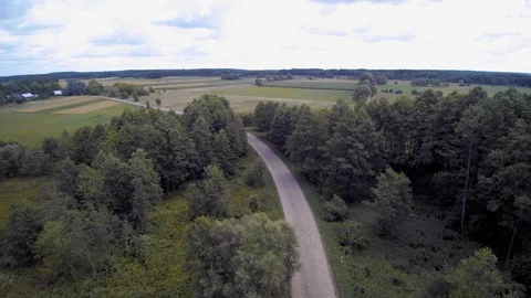 Fly a drone over a stone road, lowering the camera down Video stock 114423293