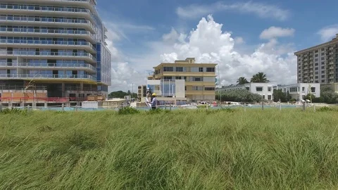 Fly by drone shot of Architect with plans in fron of his project. Stock Footage 70535338