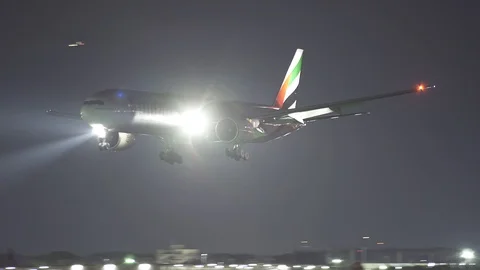 Fly Emirates Plane Boeing 777 night landing at Rome Stock Footage 90532011