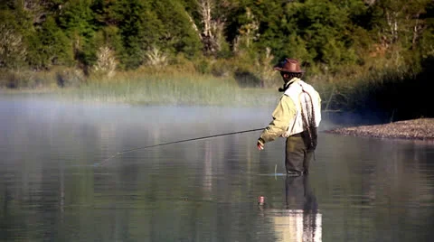 Fly fisherman casting from coast Stock Footage 22661895