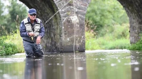 Fly-fisherman fishing in river Stock Footage