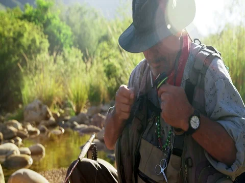 Fly fisherman preparing string to tie on hook Stock Footage 75245759