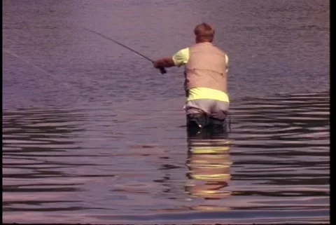 Fly Fisherman in waders casting Stock Footage 176453397