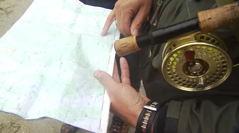 Fly fishers looking at map Stock Footage 54592217