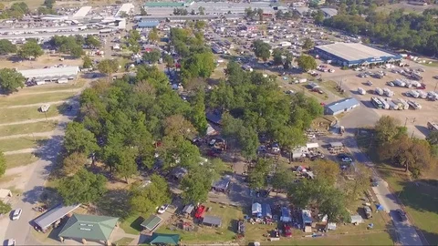 Fly Forward High Overtop Large Flea Market and Pan Down Stock Footage 76345653