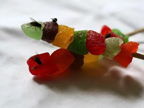 Fly infested candy poses a serious health risk, unhygienic food for bacteria Stock-Fotos