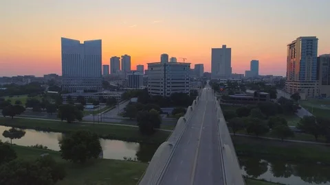 Fly L to R over Fort Worth's 7th St. Bridge at SUNRISE sun peaks out Stock Footage 78502768