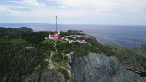 A fly by of the Long Point Lighthouse and cliffs at Crow Head Stock Footage 228688527
