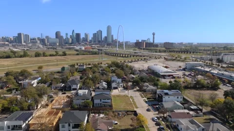 Fly low over gentrified home construction in near downtown Dallas skyline Stock Footage 324773283