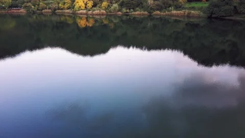 Fly low over the lake. calm water. Trees reflected in the water. drone flies low Stock Footage 144420196