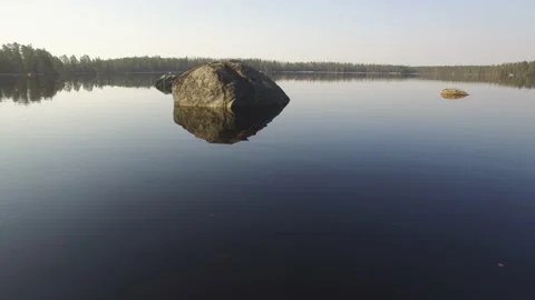 Fly on a mirror lake surface Stock Footage 165624186