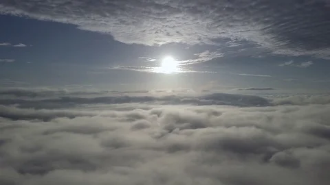 Fly moving backward, above the clouds during sunrise. Stock Footage 80014222