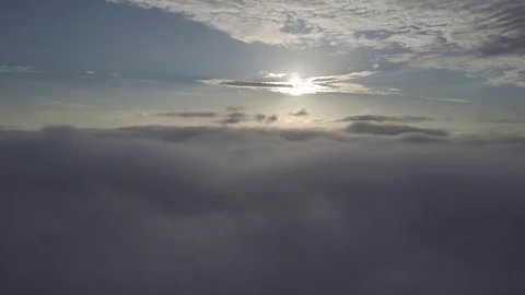 Fly moving backward, above the clouds during sunrise. Stock Footage 80014434