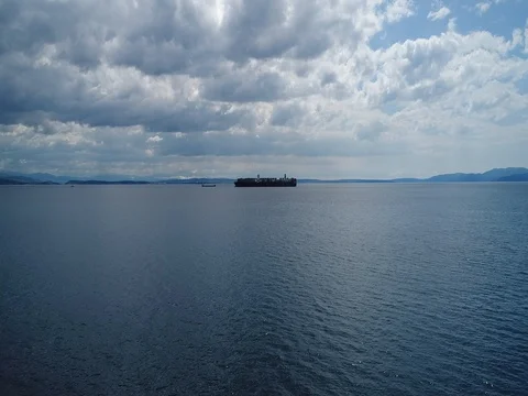 Fly to or approaching container ship on a cloudy sunny day Stockbeeldmateriaal 75477640