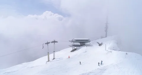 Fly out of clouds, Villars slopes - Aerial 4K Stock Footage 106297161