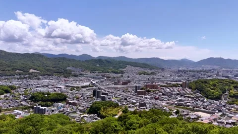 Fly out from forest towards quiet district in Hiroshima Vídeos de archivo 340275111