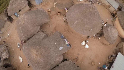 Fly over African huts during the wet season color correction Stock Footage 84072308