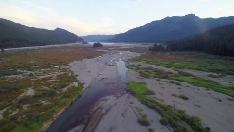 Fly by over along a small creek in mountain hills side Stock Footage 42945682