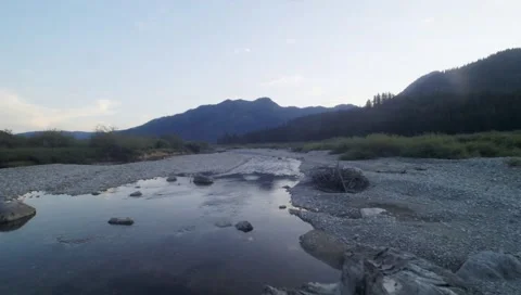 Fly by over along a small creek in mountain hills side Stock Footage 42946340