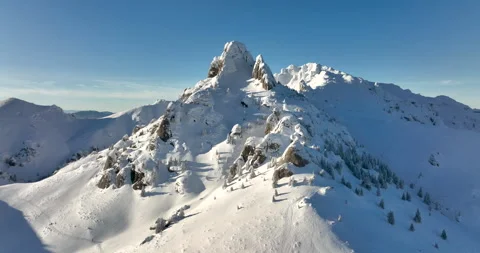 Fly over and around the mountains of Ciucas Romania in January 2022 Sunny day. Stock Footage 170199245