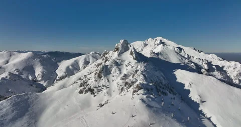 Fly over and around the mountains of Ciucas Romania in January 2022 Sunny day. Stock Footage 170200281