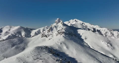 Fly over and around the mountains of Ciucas Romania in January 2022 Sunny day. Stock Footage 170200325